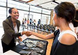 two people shaking hands smiling