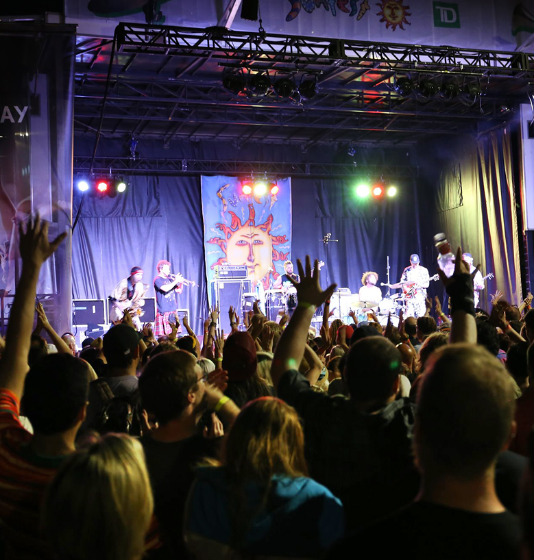 audience cheering for musicians on a stage