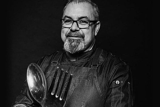 Chef with giant spoon and fork