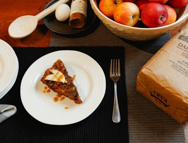 Table with a fresh slice of apple pie alongside arva mills flour