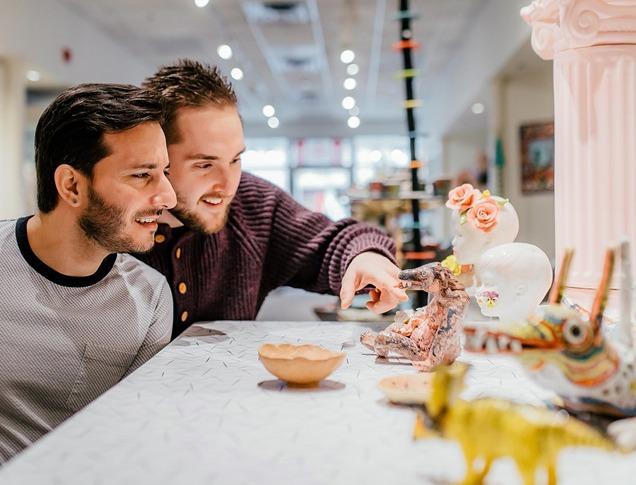 Two people observing various ceramics at Jonathon Bancroft-Snell Gallery  locate din London, Ontario