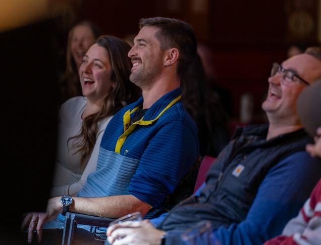 A crowd of people laughing at a comedy show in London, Ontario.