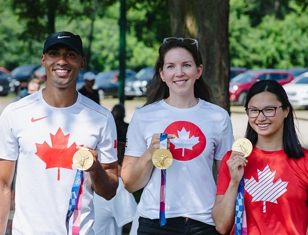 Damian Warner, Susanne Grainger and Maggie MacNeil holding their Olympic Gold Medals