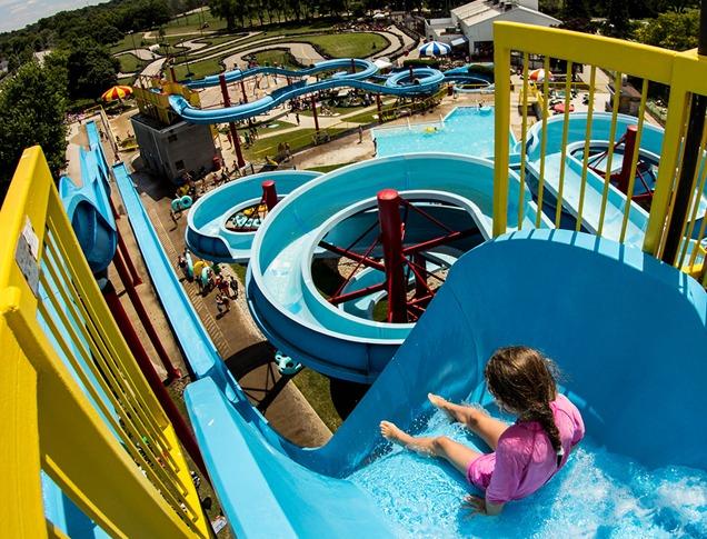 A young girl about to go down a large water slide on a hot summer day at East Park in London, Ontario