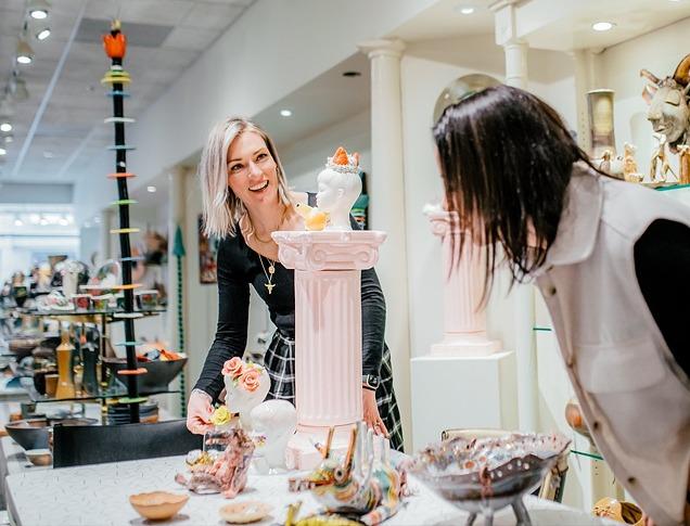 Two women looking at various pieces of ceramic art in the Jonathon Bancroft-Snell Gallery located in London, Ontario, Canada.