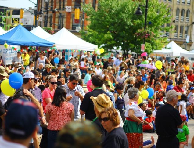 A large group of people gathered for an outdoor event in downtown London, Ontario