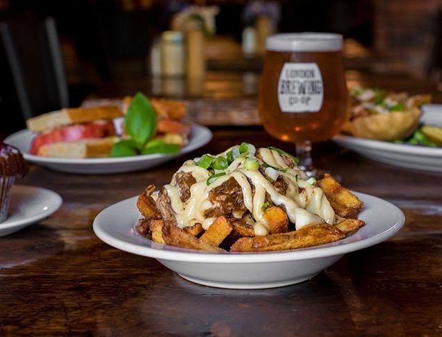 Various plates of food on arranged on a table at The Root Cellar in London, Ontario