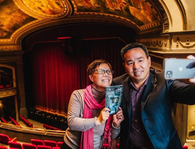 A husband and wife taking a selfie photo at the balcony seating area before a theatre performance in Grand Theatre located in London, Ontario