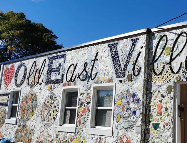 A mosaic mural on the side of a building decorated to spell out 'I love Old East Village'  located in London, Ontario