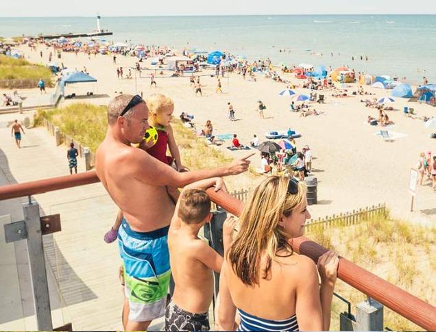 A family enjoying the view overlooking Grand Bend's beachfront on a hot summer day