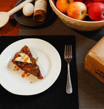 Table with a fresh slice of apple pie alongside arva mills flour