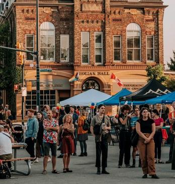 A crowd of people at an outdoor festival in Old East Village in London, Ontario.