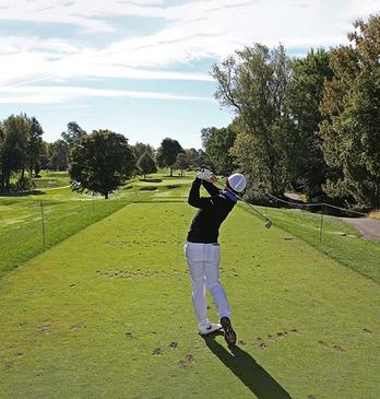 A person hitting a golf ball at the Thames Valley Golf Course locate din London, Ontario, Canada