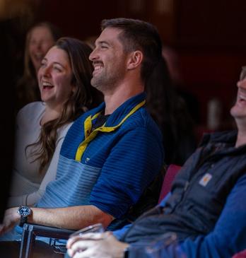 A crowd of people laughing at a comedy show in London, Ontario.