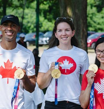 Damian Warner, Susanne Grainger and Maggie MacNeil holding their Olympic Gold Medals