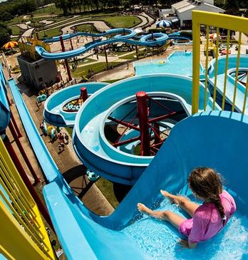 A young girl about to go down a large water slide on a hot summer day at East Park in London, Ontario