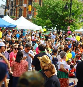 A large group of people gathered for an outdoor event in downtown London, Ontario