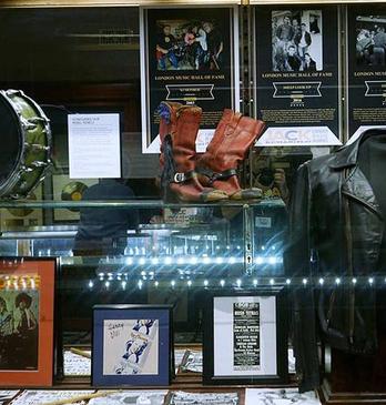 photos, jacket and drum in a showcase for the london music hall of fame
