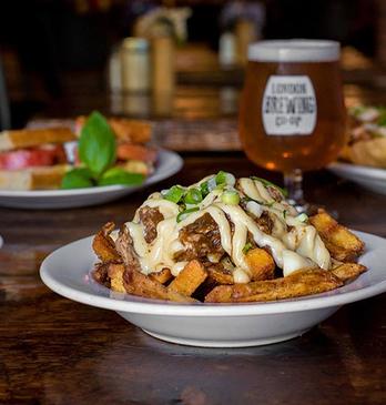 Various plates of food on arranged on a table at The Root Cellar in London, Ontario