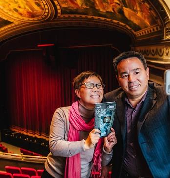 A husband and wife taking a selfie photo at the balcony seating area before a theatre performance in Grand Theatre located in London, Ontario