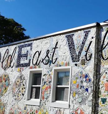 A mosaic mural on the side of a building decorated to spell out 'I love Old East Village'  located in London, Ontario