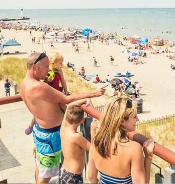 A family enjoying the view overlooking Grand Bend's beachfront on a hot summer day