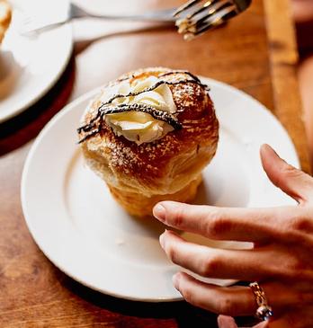 A person about to eat a pastry called a 'cruffin' from Black Walnut Bakery Café located in London, Ontario