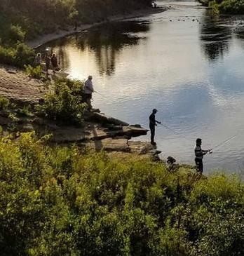 Two girls fishing in river