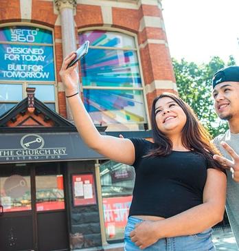 Two people taking a selfie in downtown London, Ontario