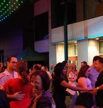 A salsa street party at Dundas place with people are dancing and enjoying the atmosphere.
