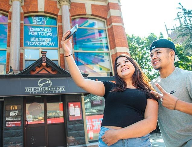 Two people taking a selfie in downtown London, Ontario