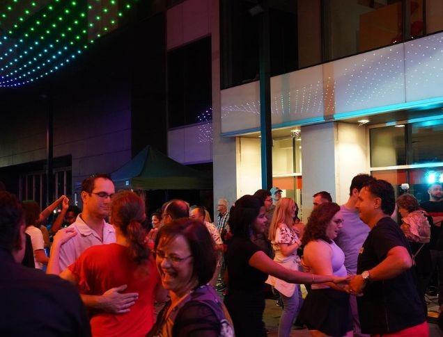 A salsa street party at Dundas place with people are dancing and enjoying the atmosphere.