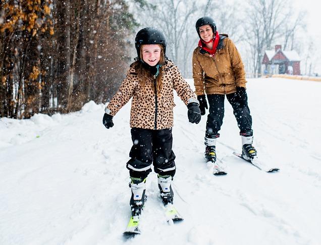 A mother and daughter ski together on a trail at Boler Mountain in London, Ontario