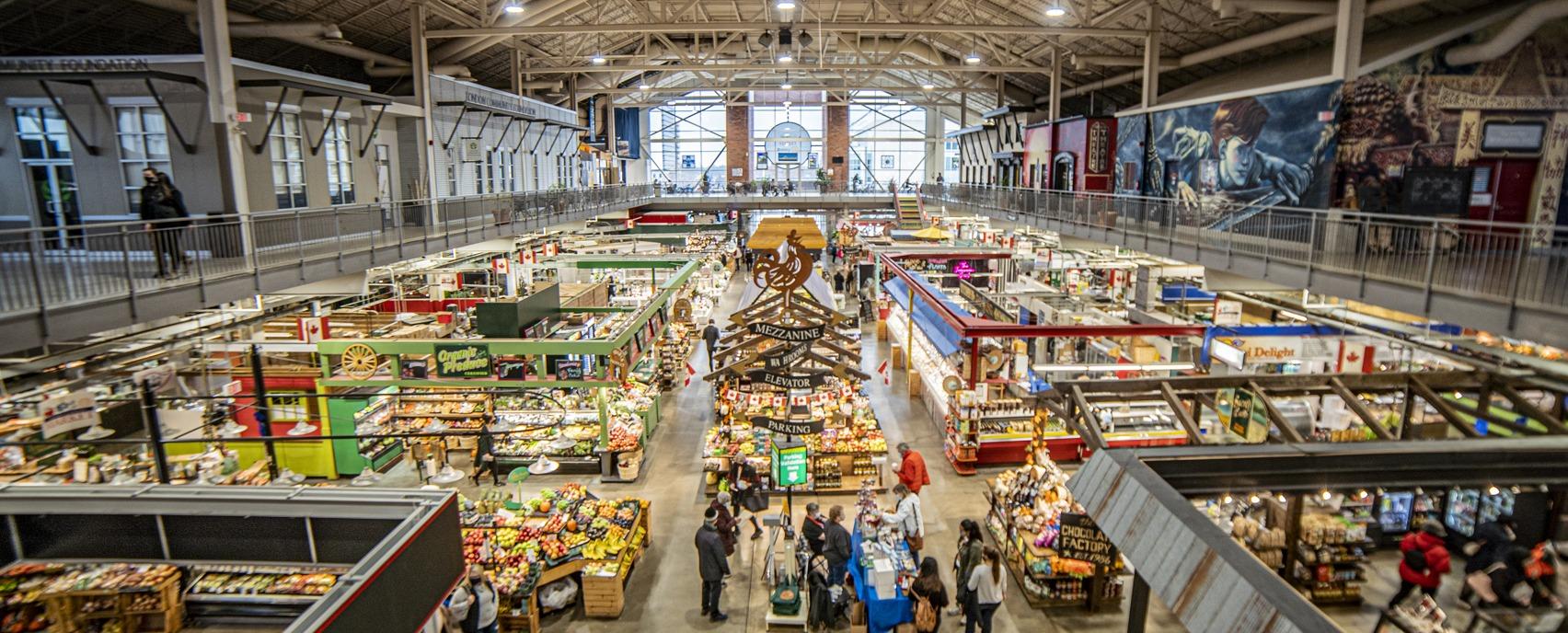 An aerial view of the main floor of the Covent Garden Market with various vendors and shoppers located in London, Ontario