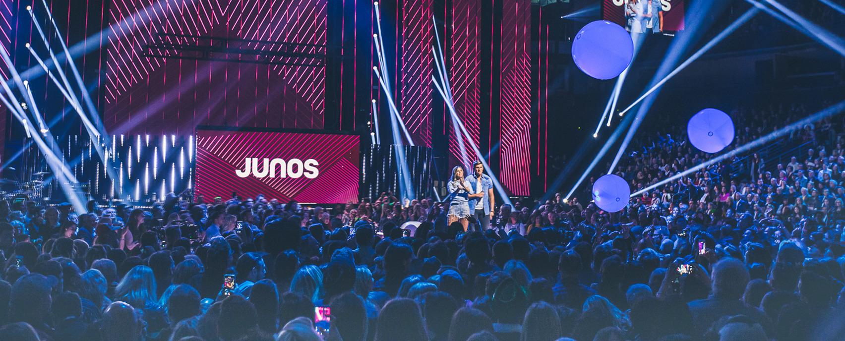 audience looking at stage with two presenters