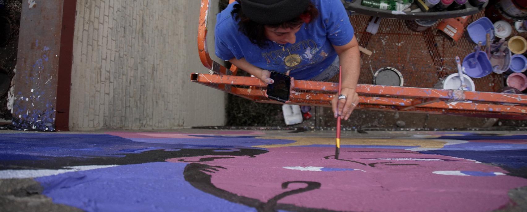 Milkbox The Artist painting a mural at 420 Elizabeth Street in London, Ontario