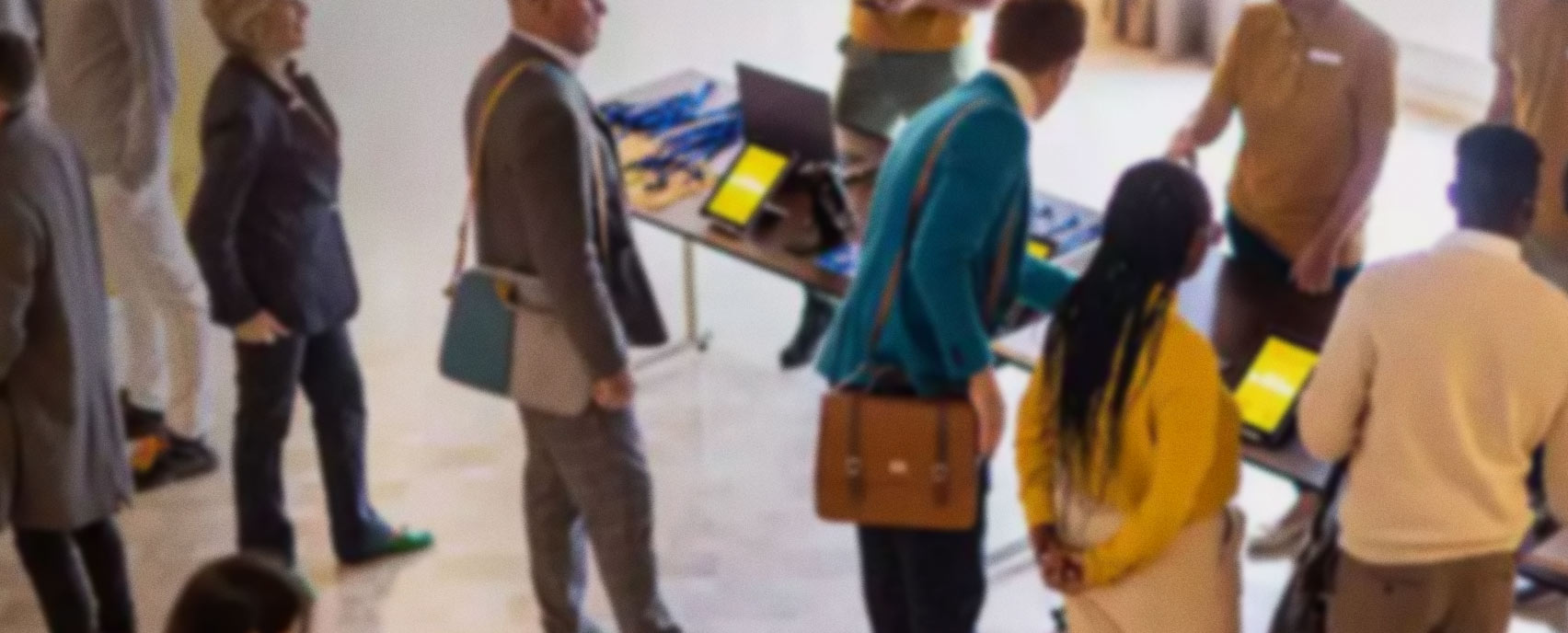 people gathered around a table looking at brochures during a conference