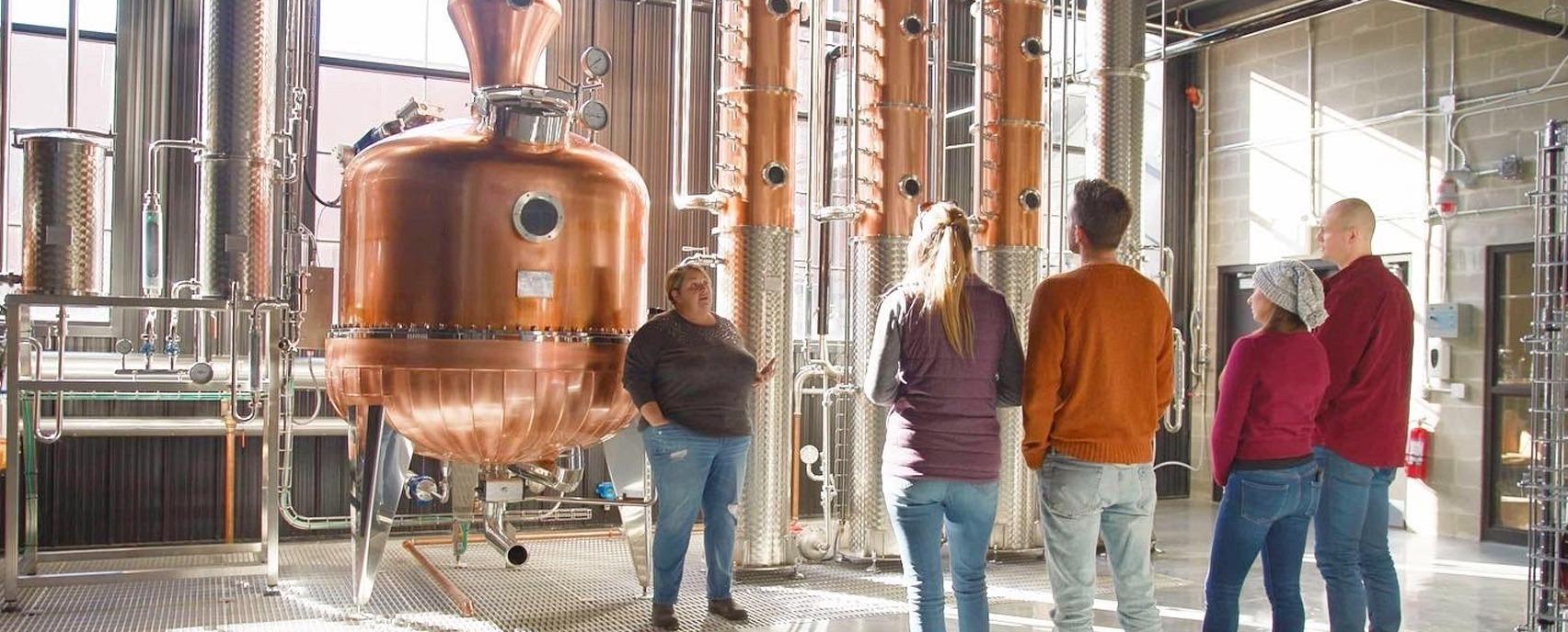 A group of people taking a tour of Paradigm Spirits Distillery in London, Ontario