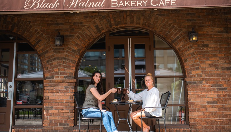 Two women enjoying mugs of fresh coffee