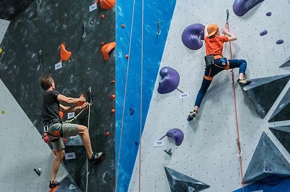 Two people climbing a wall indoors at Junction Climbing Centre locate din London, Ontario