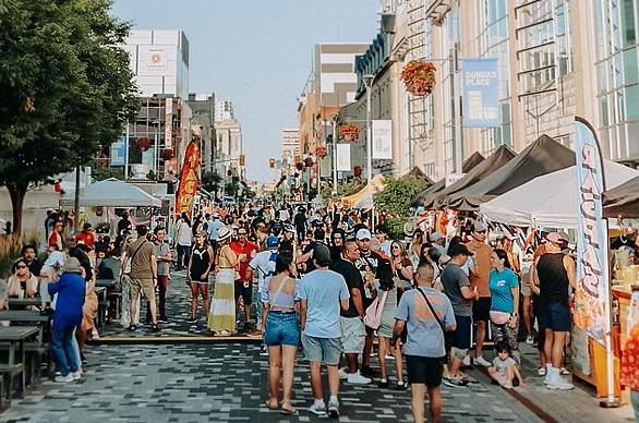 crowd of people walking down dundas street