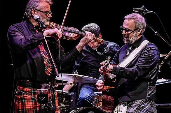 Musicians from the band The Celtic Kitchen Party playing live on stage