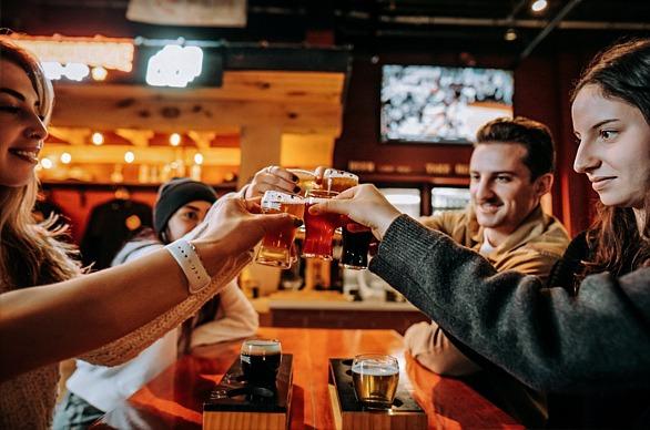 A group of people drinking beer at the PowerHouse Brewery located in London, Ontario