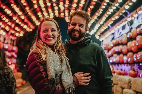 A couple standing in front of display at Pumpkins After Dark, located in London, Ontario