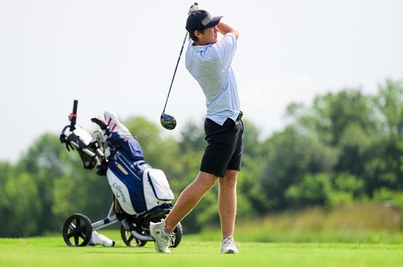 A male golfing on a sunny day