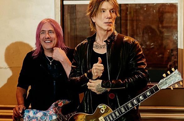Members of the band the Goo Goo Dolls holding their instruments