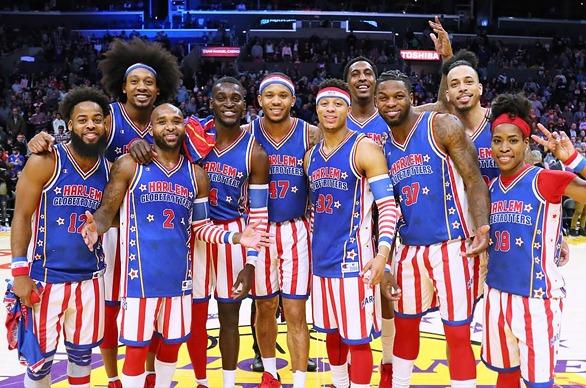 The Harlem Globetrotters basketball team posing for a photo on a basketball court