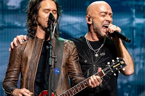 Band members of the rock group +LIVE+ performing on stage