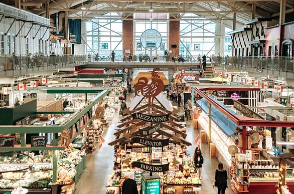 An aerial view of inside Covent Garden Market, showcasing various vendors and customers browsing, located in London, Ontario