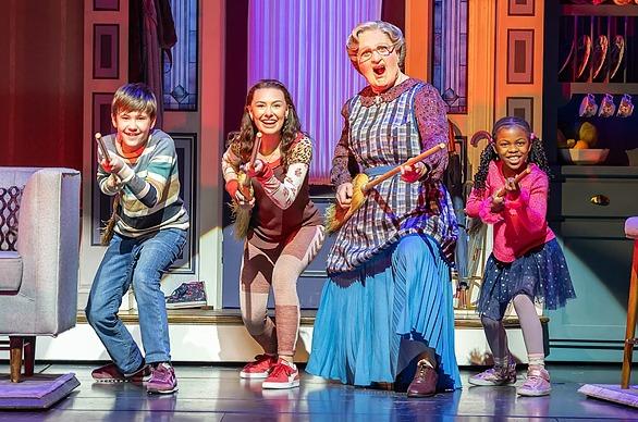 Cast members from the theatrical play Mrs. Doubtfire, performing a scene live on stage